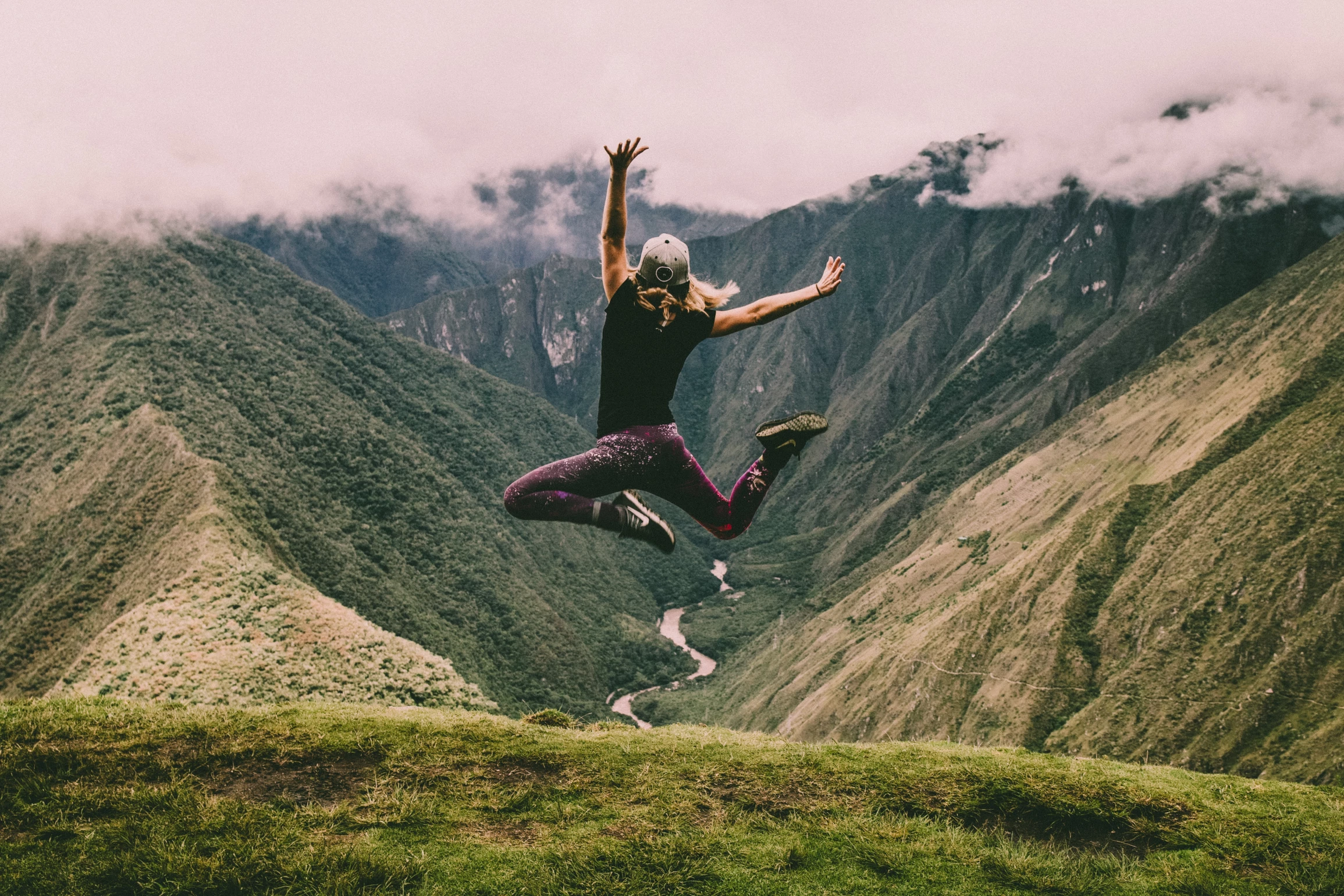 girl jumps in hilltop