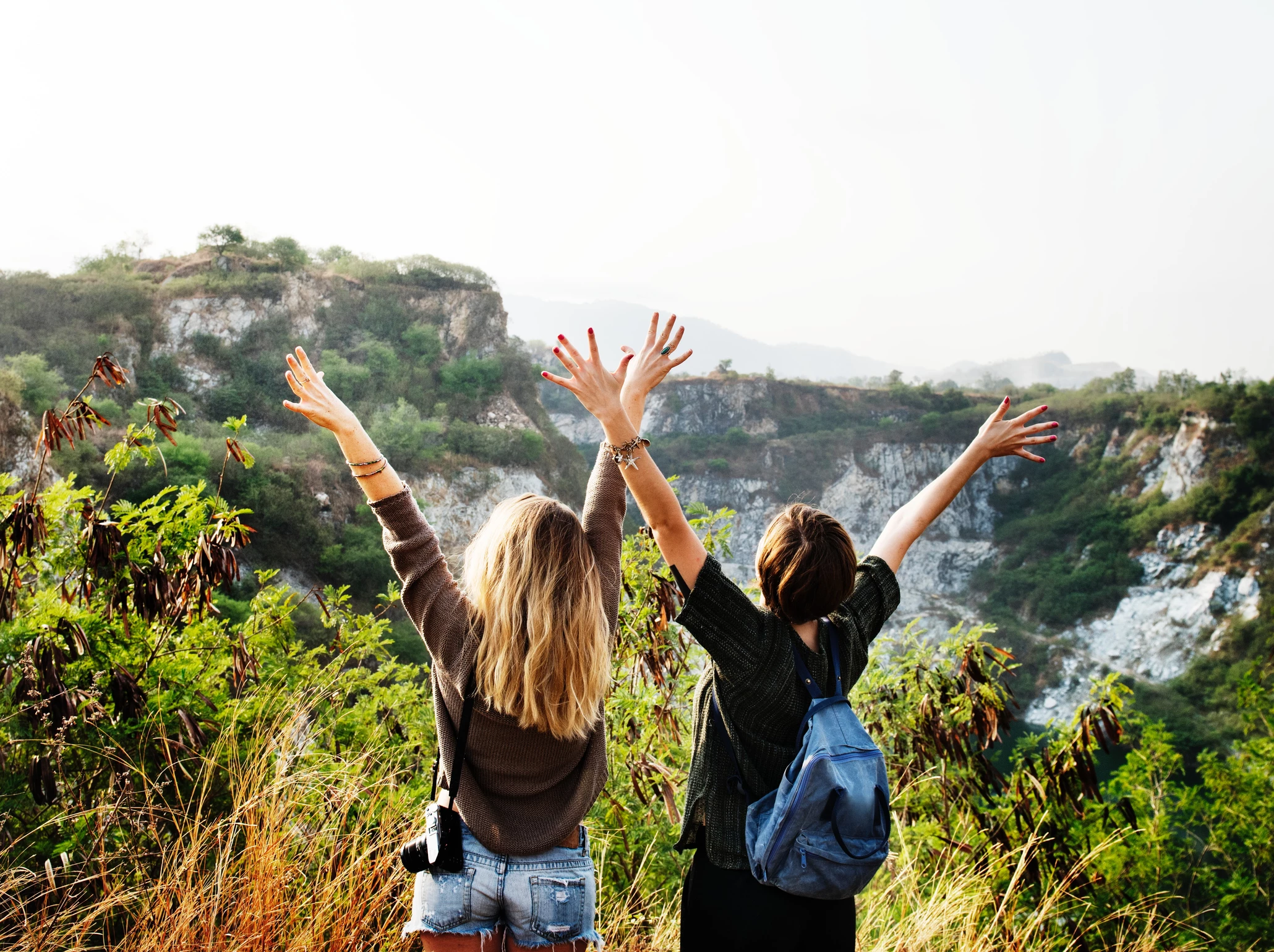 2 women raising hands 