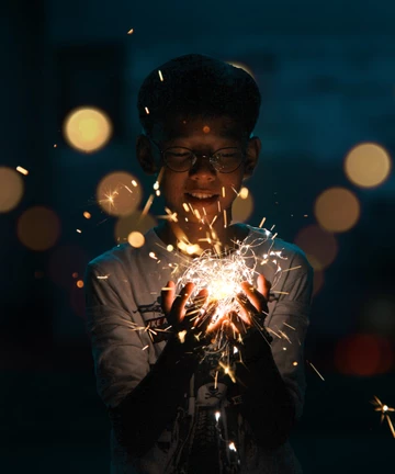 boy holds fireworks